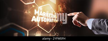 Marketing automation on the virtual screen. Man clicks on the inscription Marketing Stock Photo