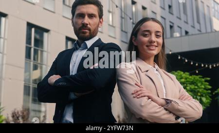 Happy smiling Caucasian two coworkers colleagues businessman business male guy man with businesswoman girl female woman company managers posing Stock Photo
