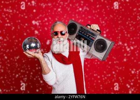 Portrait of his he nice cool handsome cheerful glad positive gray-haired man in pullover sweater having fun celebratory occasion nightclub disco Stock Photo