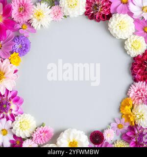 Flower frame of flowers asters, dahlias, calendula. Floral Greeting card with place for the text in center. Nature trendy decorative design. Nature concept. Flat lay. Stock Photo