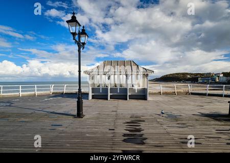 A Victorian shelter on the pier at the English seaside resort of Cromer in Norfolk on the East coast. Popular traditional coastal family holidays. Stock Photo