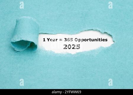 Inspirational quote 1 Year 2025 equal to 365 opportunities seen through torn blue paper. Stock Photo