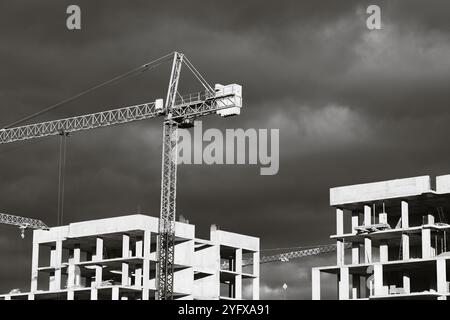 High-rise buildings under construction, featuring unfinished concrete and brick structures. While intense fighting continues in eastern Ukraine, the western regions are experiencing a construction boom. Cities in western Ukraine, such as Lviv, Ivano-Frankivsk, and Uzhhorod, have become hubs of active building and infrastructure development. These areas are attracting both internally displaced people and new investors, driving demand for housing, commercial real estate, and public facilities. The economic growth in the western regions contrasts sharply with the destruction and instability in th Stock Photo