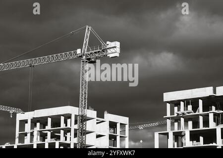 High-rise buildings under construction, featuring unfinished concrete and brick structures. While intense fighting continues in eastern Ukraine, the western regions are experiencing a construction boom. Cities in western Ukraine, such as Lviv, Ivano-Frankivsk, and Uzhhorod, have become hubs of active building and infrastructure development. These areas are attracting both internally displaced people and new investors, driving demand for housing, commercial real estate, and public facilities. The economic growth in the western regions contrasts sharply with the destruction and instability in th Stock Photo