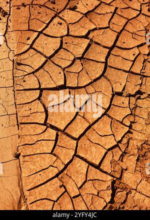 Dry and cracked red brown soil ground during drought, viewed from above. Hiking through Fuerteventura. Canary Islands, Spain. Stock Photo
