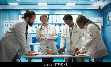 Medical staff collaborates on diagnostic procedures and treatment plans. Radiology specialists work on accurate diagnosis and effective disease prevention, healthcare industry insurance. Camera B. Stock Photo