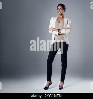 Business, woman or arms crossed with thinking in studio for career growth, job opportunity or ambition. Professional, indian person or thoughtful with Stock Photo