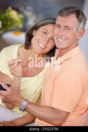 Senior couple, portrait and engagement ring in home for relationship, commitment and romance. Elderly people, proposal and jewelry for hand in Stock Photo