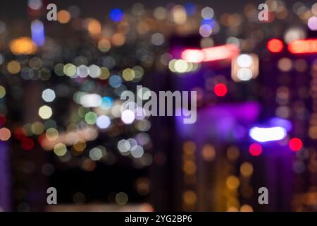 View of skyscrapers building and modern city skyline with colorful blur bokeh light background. Jakarta, Indonesia. Blurred cityscapes background Stock Photo