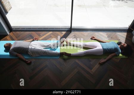 Woman and man with Down syndrome practice yoga Stock Photo