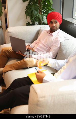 Two businessmen sitting in office Stock Photo