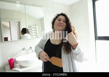Woman brushing hair Stock Photo