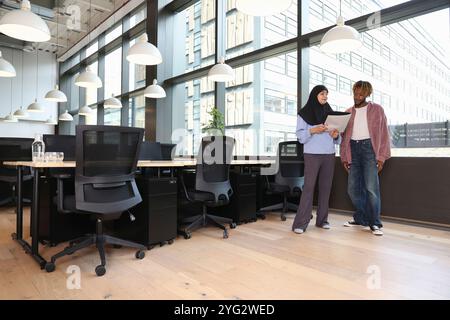 Businessman and businesswoman discussing in office Stock Photo