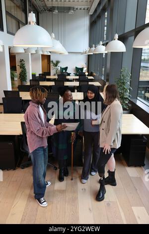 Diverse group of business people discussing in office Stock Photo