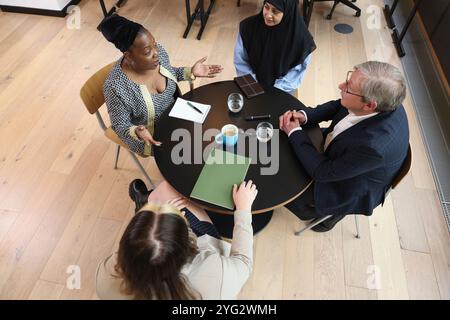 Diverse group of business people discussing in office Stock Photo