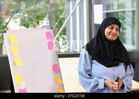 Businesswoman leading meeting in office Stock Photo