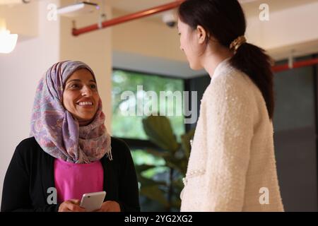 Women talking in modern office Stock Photo