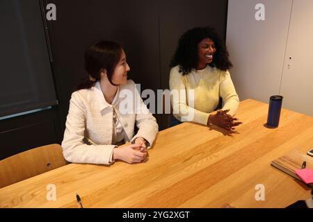 Smiling women sitting in office Stock Photo