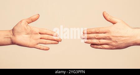 Rescue, helping gesture or hands. Hands man and woman reaching to each other, support. Giving a helping hand. Hands of man and woman on gray Stock Photo