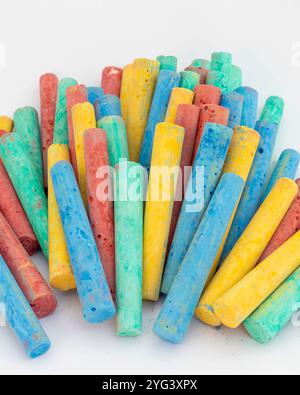 Chalks in a variety of colors on white background Stock Photo
