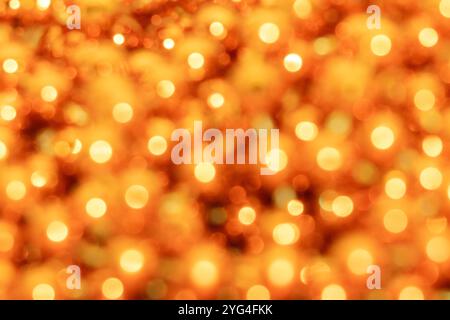 A warm and vibrant background featuring golden yellow bokeh lights with soft, glowing circles. The blurred effect creates a cozy, radiant ambiance, ma Stock Photo