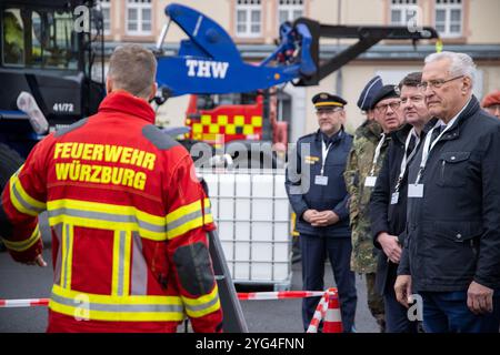 06 November 2024, Bavaria, Würzburg: Bavaria's Minister of the Interior Joachim Herrmann (CSU, r) visits the exhibition as part of the 'MainTex 2024' anti-terror exercise. The police, Bundeswehr, fire department, BRK and other emergency services demonstrate their skills and equipment. The exercise scenarios, which have been played out since November 4, include fictitious threats from chemical, biological, radiological and nuclear substances. Photo: Pia Bayer/dpa Stock Photo