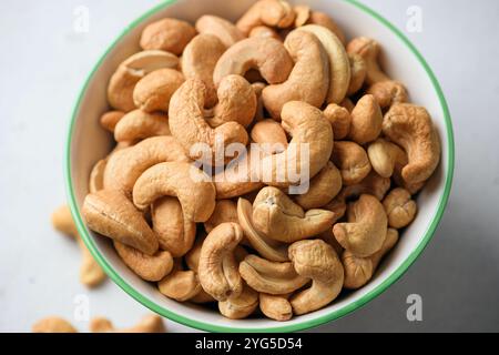Organic roasted cashew nuts in bowl closeup view. Healthy vegan nuts Stock Photo