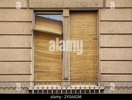 old building with broken window shutter Stock Photo