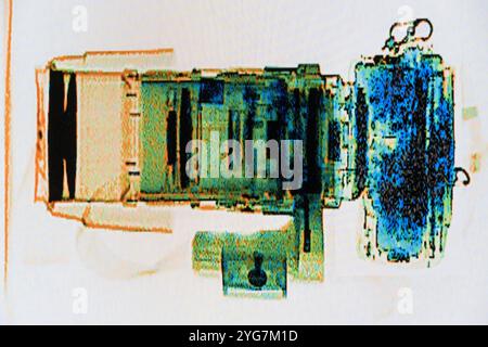 digital security xray image of SLR camera with telephoto lens showing lens elements Stock Photo