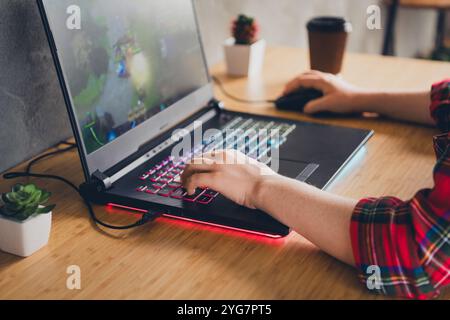 Person using a colorful laptop with a wireless mouse Stock Photo