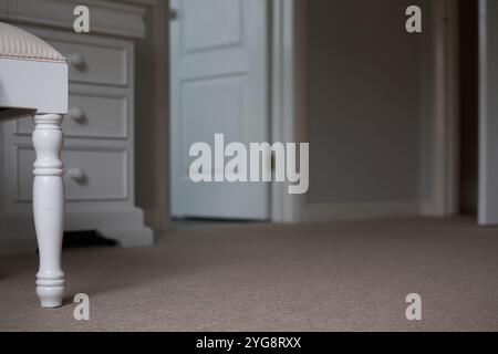 Close up of a stool leg in beige bedroom from floor level Stock Photo