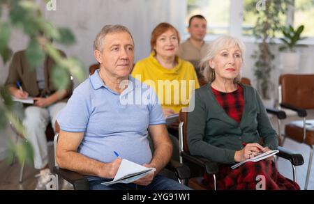 Group of mature students attending lecture in college Stock Photo