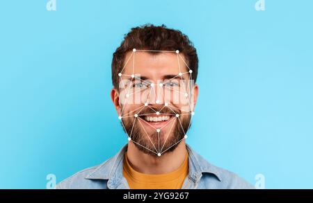 Man smiling with facial recognition lines on his face against a blue background Stock Photo