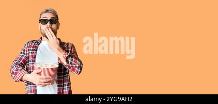 Guy in 3D glasses covers mouth with hand Stock Photo