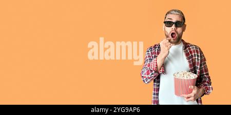 Surprised man in 3D glasses eating popcorn Stock Photo