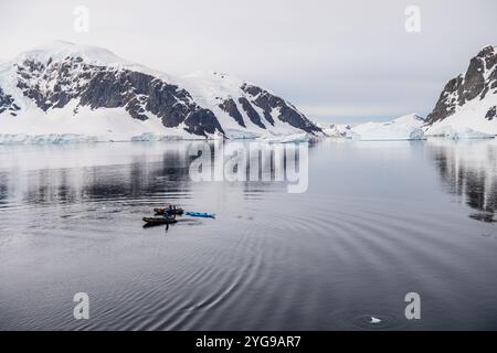 Danco Island, Antarctic Peninsula - January 31, 2024. Crew members of the Atarctic Exploration vessel Ocean Adventurer prepare zodiacs for explorations of Danco Island and its surroundings in the Antarctic Peninsula. Stock Photo