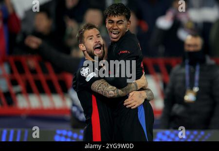 Belgrade, Serbia. 6th Nov, 2024. Barcelona's Inigo Martinez (L) celebrates his goal with his teammate Lamine Yamal during the UEFA Champions League football match between Crvena Zvezda and Barcelona in Belgrade, Serbia, on Nov. 6, 2024. Credit: Predrag Milosavljevic/Xinhua/Alamy Live News Stock Photo