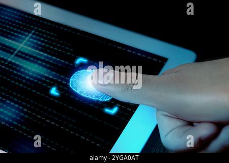 Man using fingerprint scanner in tablet by touching it, closeup Stock Photo