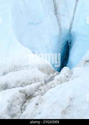 Drainage system on the surface of the ice sheet. Brown sediment on the ice is created by the rapid melting of the ice. Greenland near Kangerlussuaq. Stock Photo