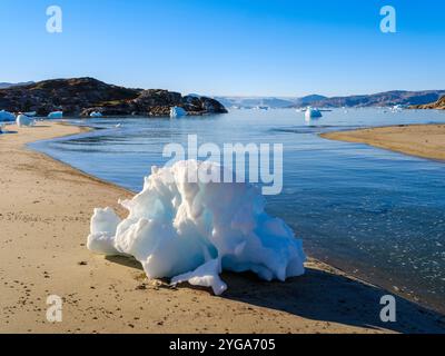 Melting ice on shore. Landscape at the Sermilik (Sermiligaaq) Icefjord in East Greenland, Ammassalik, Kingdom of Denmark. Stock Photo
