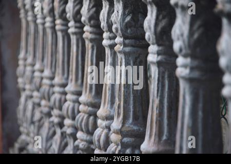 gray concrete fence pillars lined up with selective focus Stock Photo