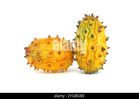 Two vibrant kiwano fruits showcasing their unique spiked appearance on a white background. Perfect for illustrating exotic and fresh produce concepts Stock Photo