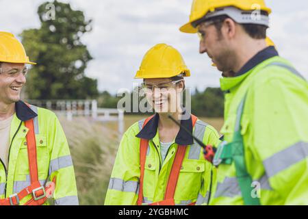 Happy smiling and laughing engineer team workers talking together relax at work. Stock Photo