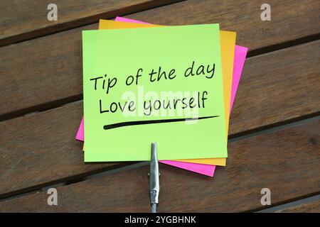 Tip of the day. Daily motivation reminder. daily motivation. sticky notes. Tip of the day Love yourself written on sticky notes Stock Photo