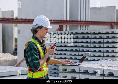 Professional engineer Caucasian male working in concrete precast plant factory control operate construction site. Stock Photo