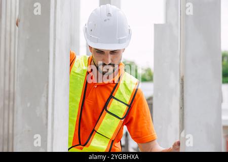 Professional engineer Hispanic Latin male working in concrete precast plant factory control operate construction site. Stock Photo