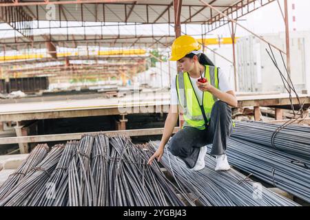Engineer worker, Officer working check steel bar strength grade for high quality products and standard in construction site. Stock Photo