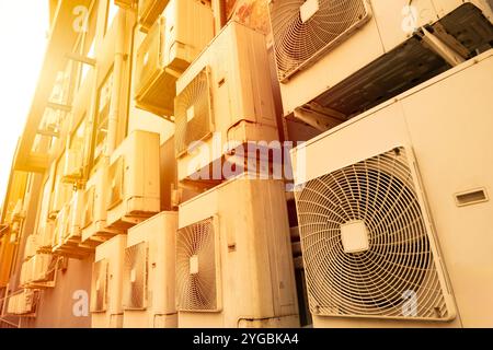 Many Air conditioner outside cooling unit office building in hot weather from global warming crisis environment impact. Stock Photo