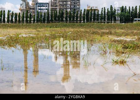 Flooding water high sea level flood, Waterlogged wet land environment impact heavy raining at Refinery oil gas plant concept. Stock Photo
