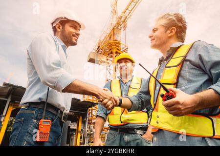 Workers team hand shaking deal with contractor happy at construction site. Engineer project business contact connection people concept. Stock Photo